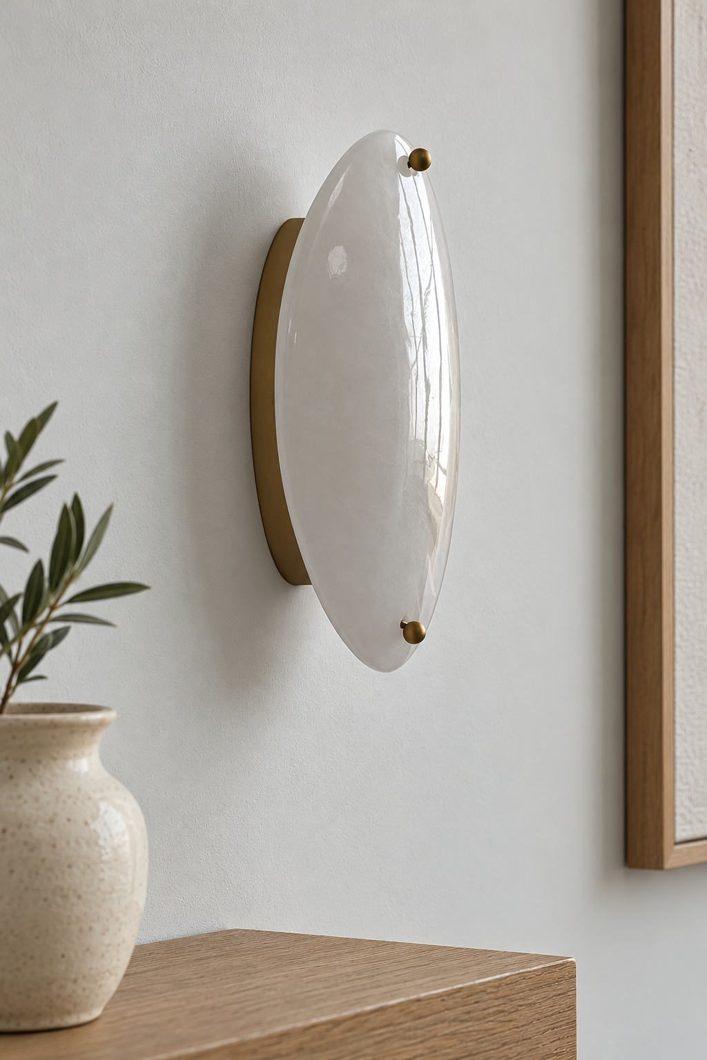 Close view of an unlit glossy white stone wall sconce