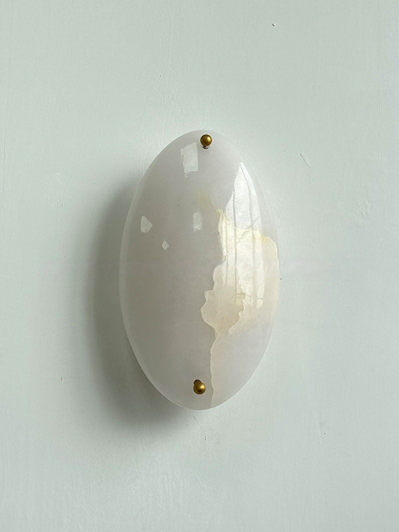 Real front view of the white stone wall sconce switched off