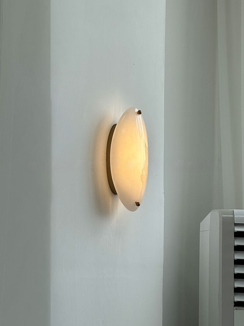 Real side view of the illuminated white stone wall sconce