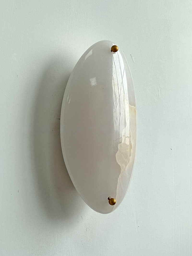 Original real close view showing the white stone face and retaining caps, switched off.
