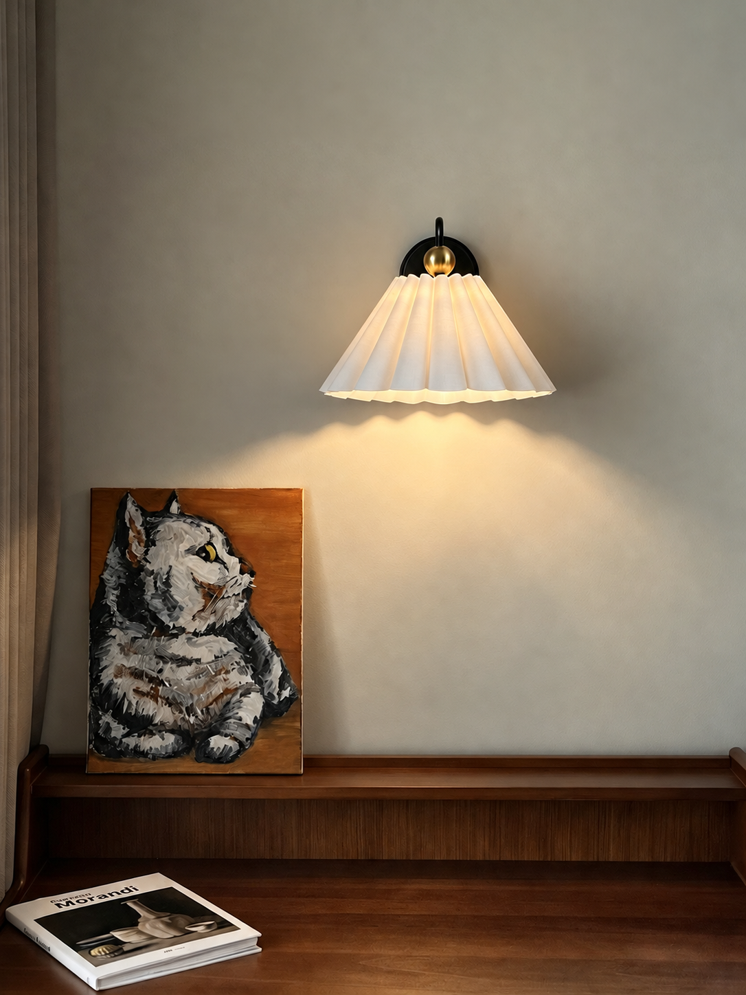 Warm illuminated pleated wall sconce above a wooden desk