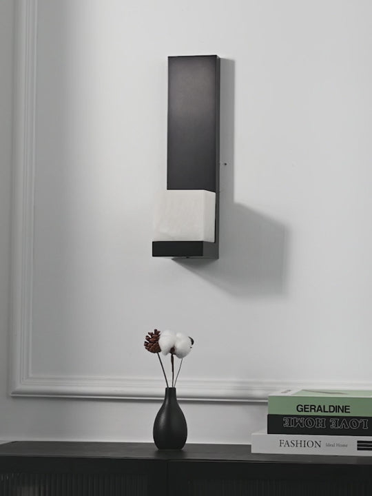 Load video: Modern Snowflake Alabaster Wall Sconce in Brushed Black - product gallery video