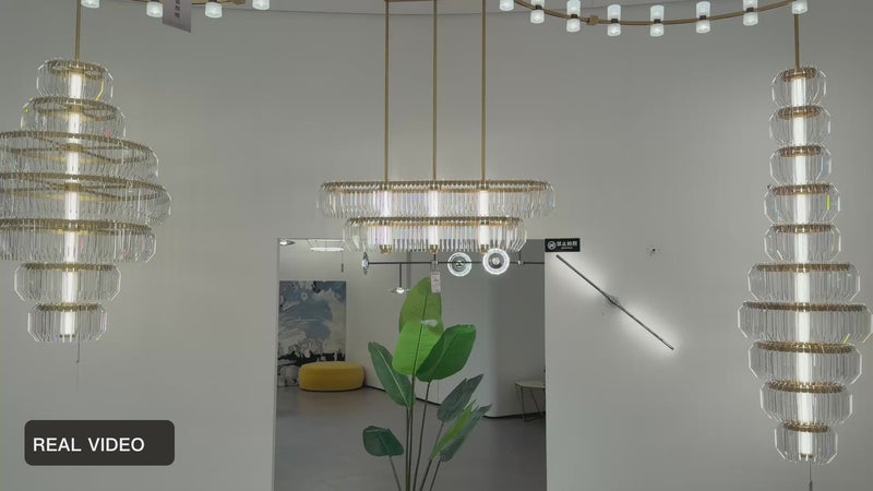 Arquelle Round Antique Brass Acrylic Tiered Chandelier showroom group real product video — REAL VIDEO · CDE original framing balanced light v1 2026-09-23