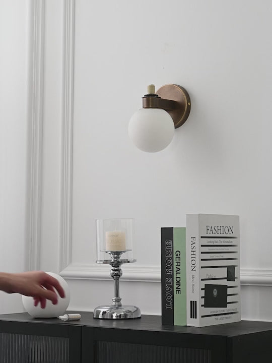 Load video: Modern Alabaster Double Globe Wall Sconce in Antique Brass - product gallery video