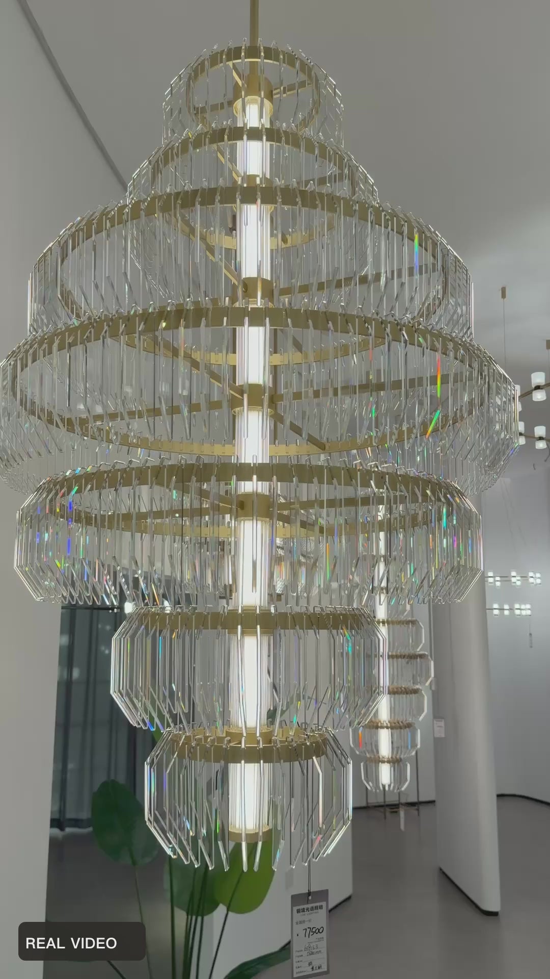 Load video: Arquelle Round Antique Brass Acrylic Tiered Chandelier acrylic detail real product video — REAL VIDEO · CDE original framing balanced light v1 2026-09-23