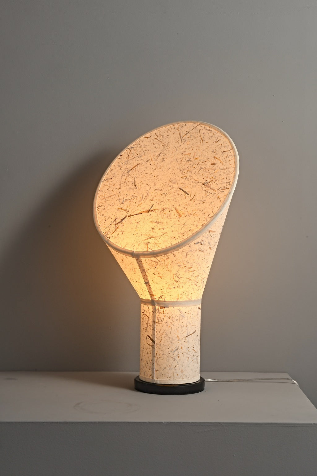 Serevane handmade paper table lamp lit from an angled real-studio view