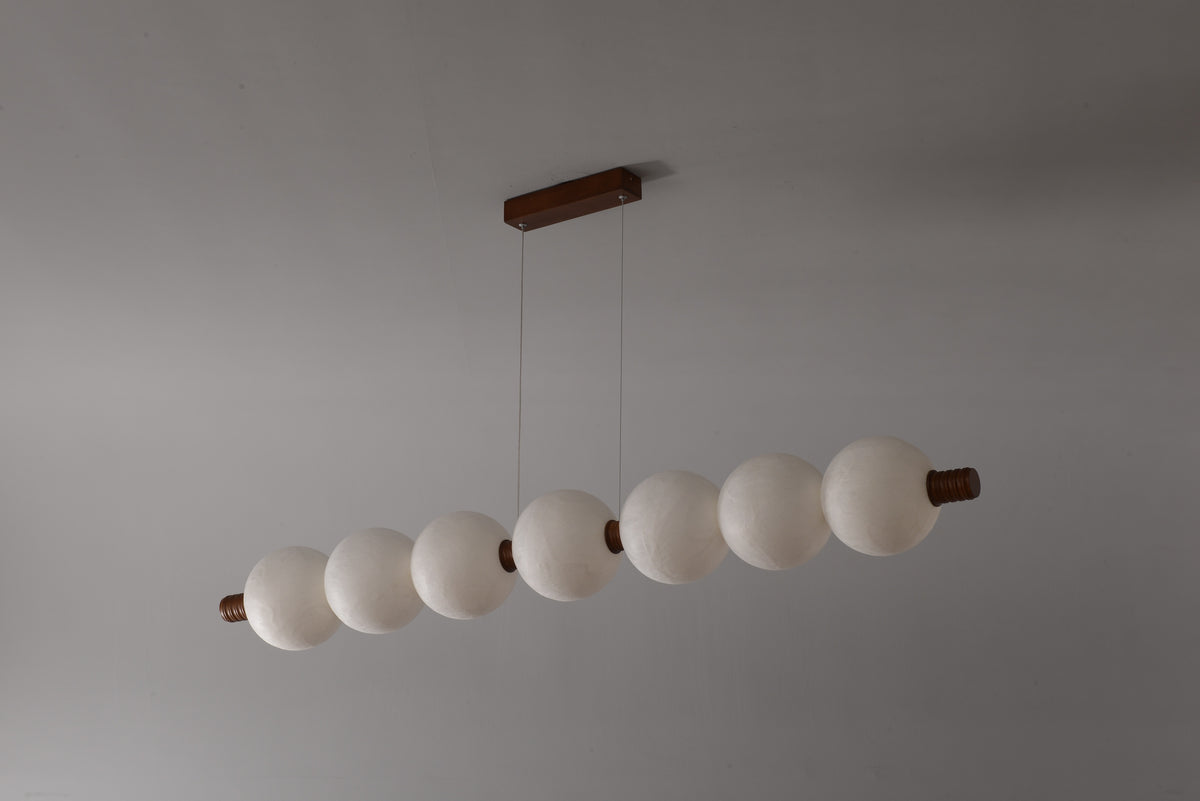 7-globe horizontal natural mulberry silk pendant with dark wood details, real product photograph