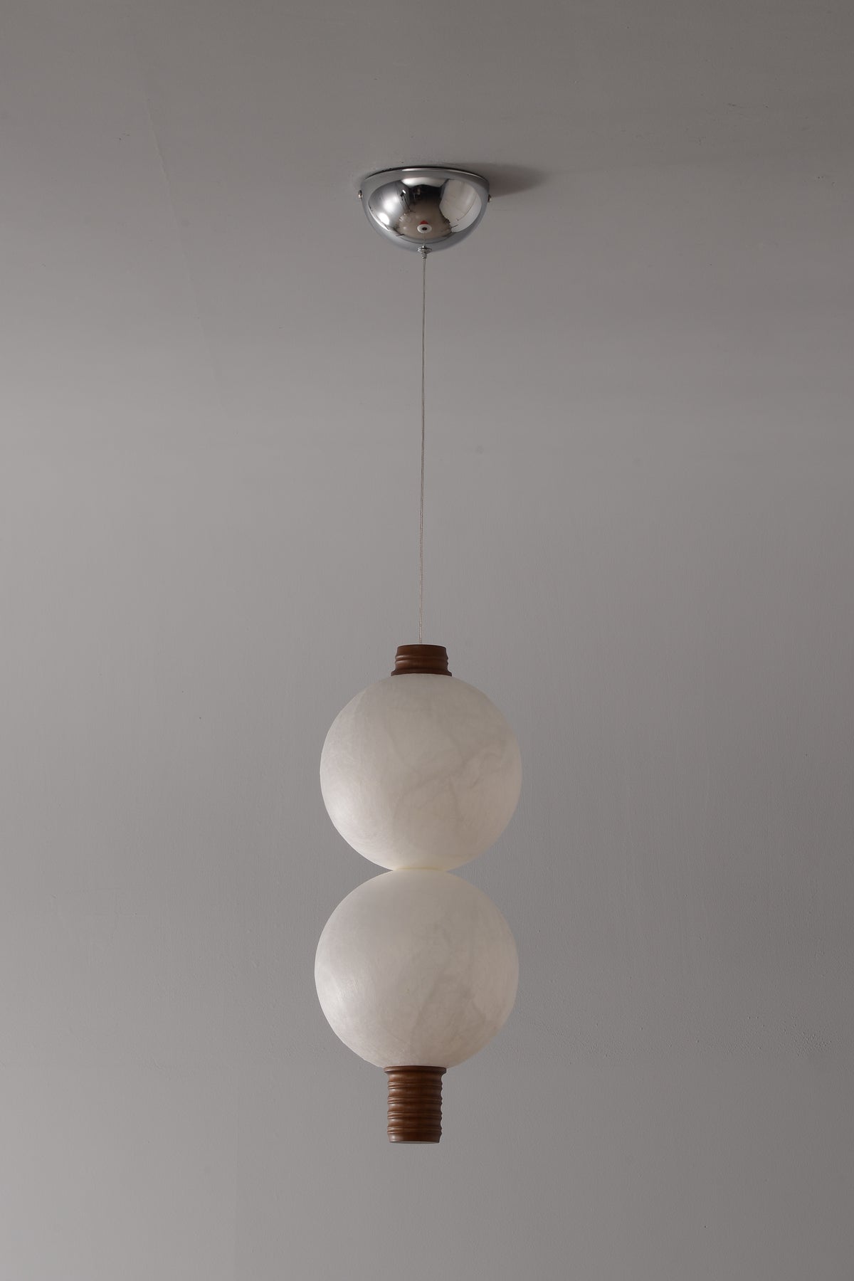 2-globe vertical natural mulberry silk pendant with dark wood details, real product photograph