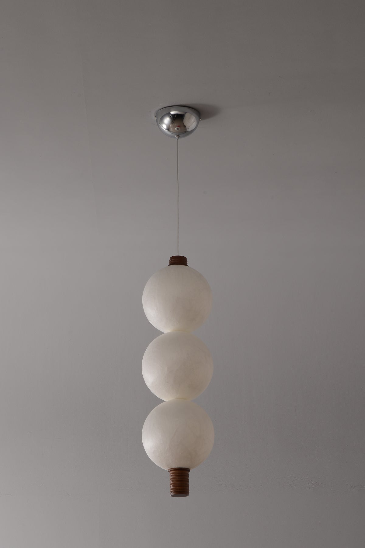 3-globe vertical natural mulberry silk pendant with dark wood details, real product photograph
