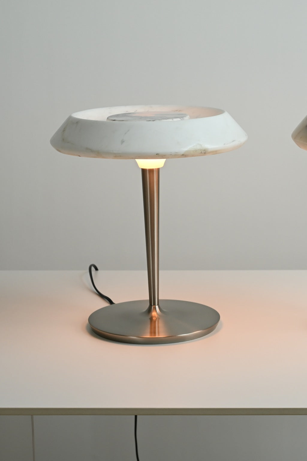 Solvenne Carrara white marble table lamp illuminated in the supplier studio