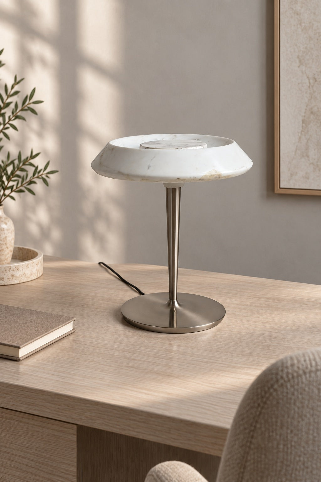 Solvenne Carrara white marble table lamp unlit on a bright home office desk