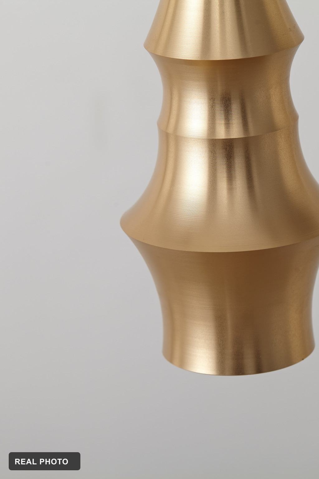 Torvelle Brushed Gold Sculptural Pendant Light real product photo 1 — REAL PHOTO · CDE corrected 2026-09-24