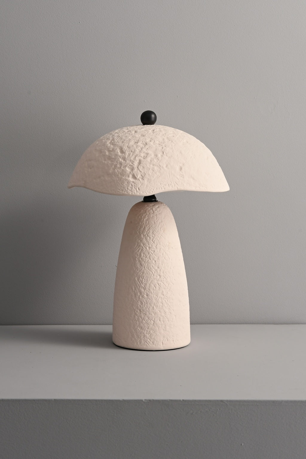 Velmurne white ceramic table lamp unlit in a real studio