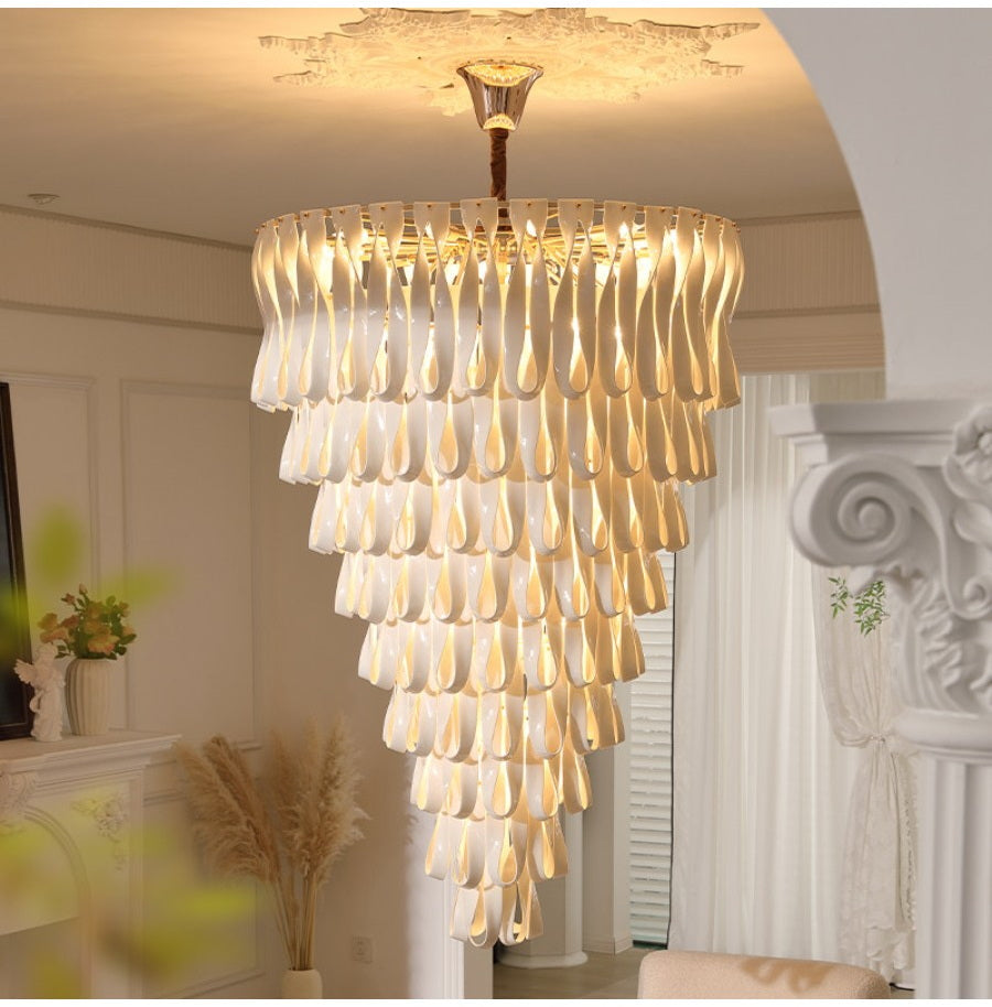 Warm lit grand ceramic ribbon chandelier in a room