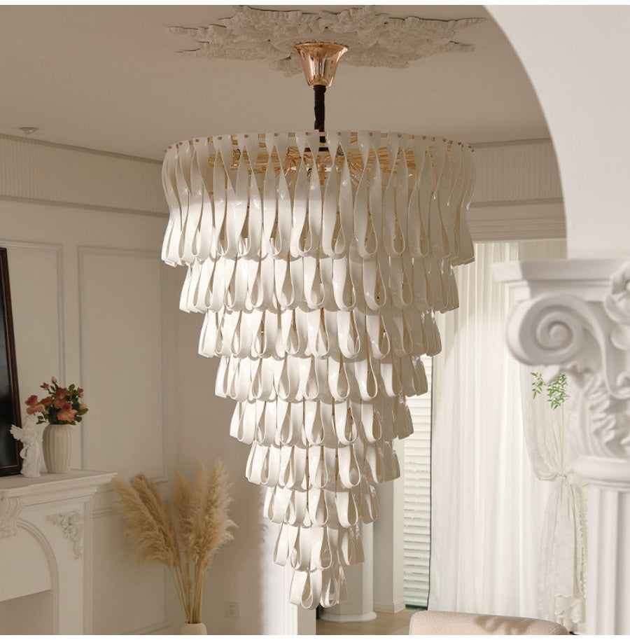 White ceramic ribbon chandelier in a bright neutral room