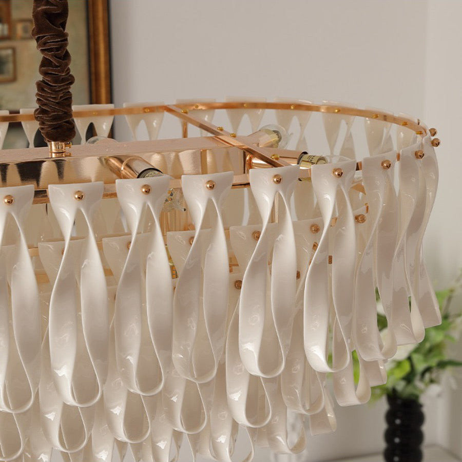 Gold-tone linear frame and ceramic ribbon attachment detail