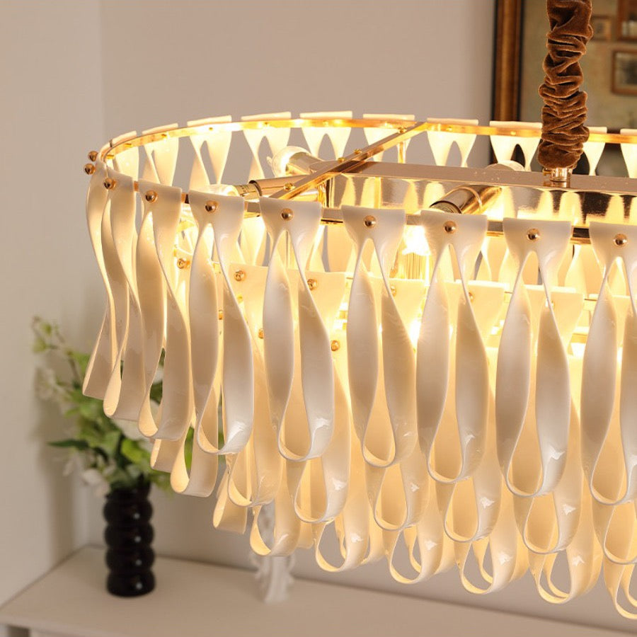 Close view of glossy ivory ceramic ribbon pieces on the linear dining chandelier