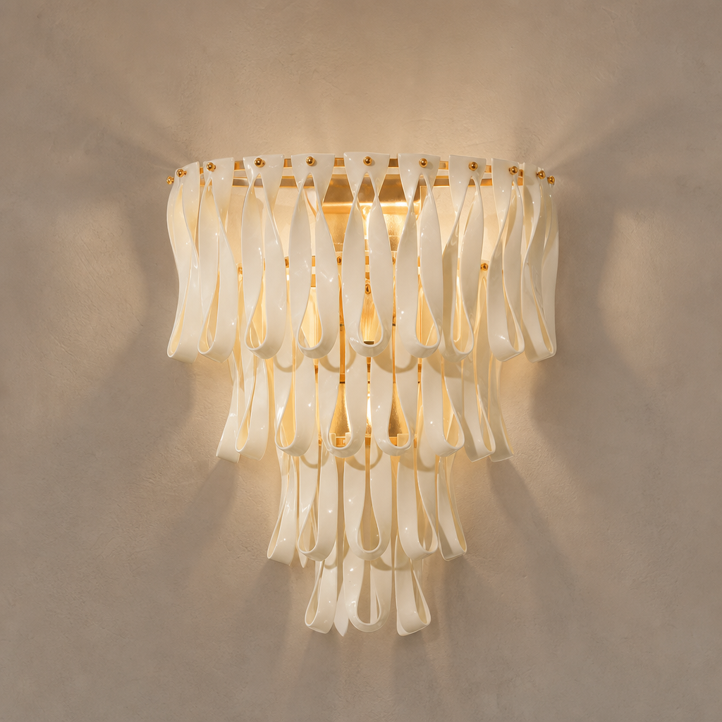 Ivory ceramic ribbon wall sconce with warm gold-tone frame