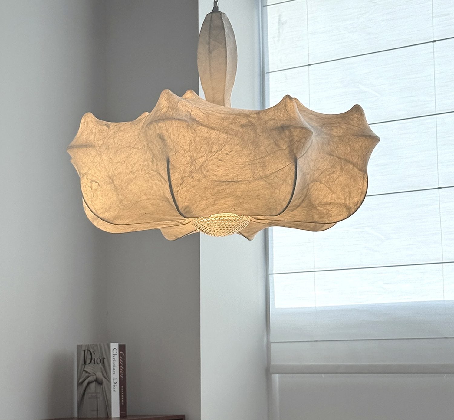 Warm sculptural silk-inspired pendant light in a modern interior