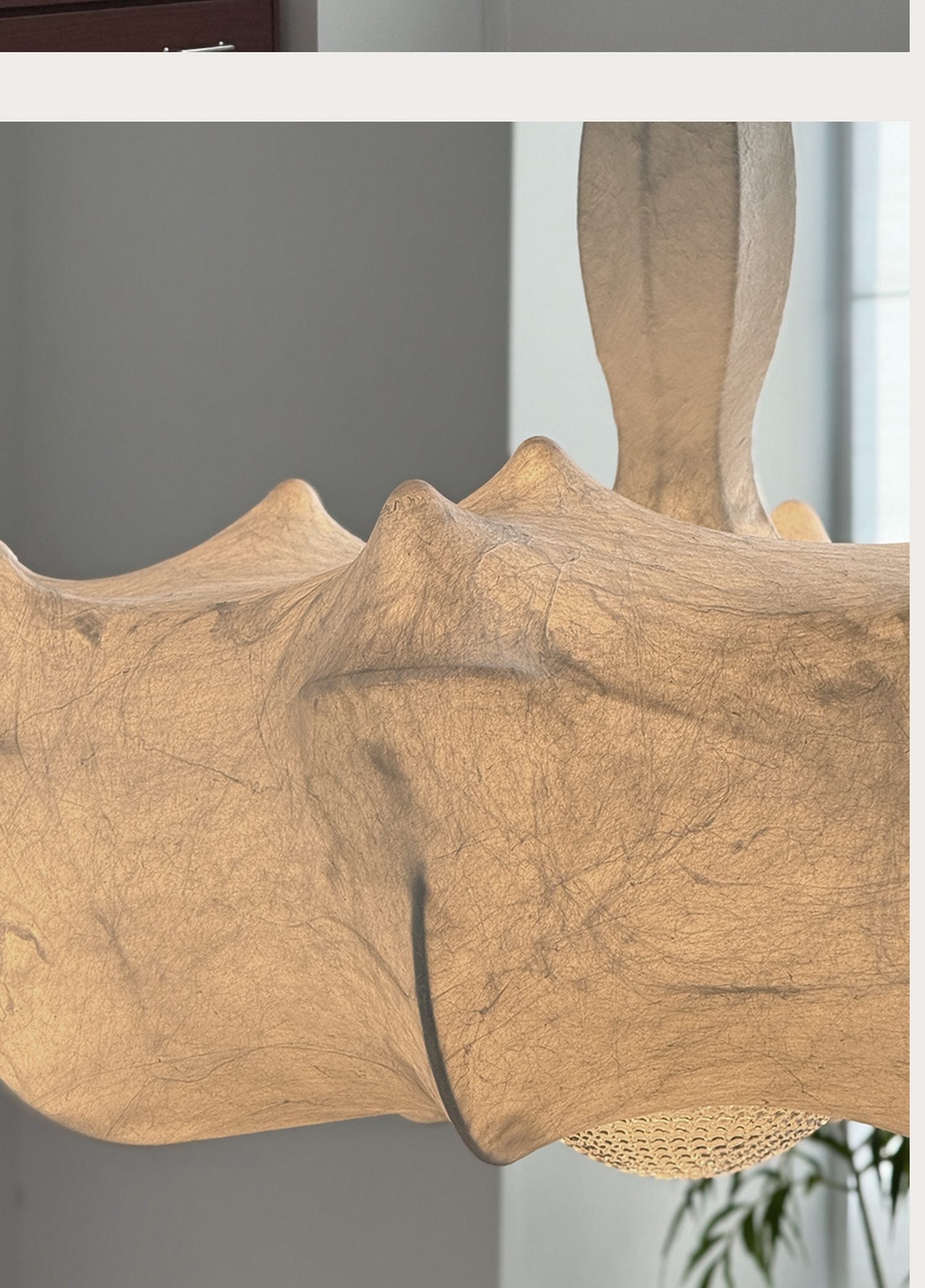 Warm amber fabric texture and folded pendant detail
