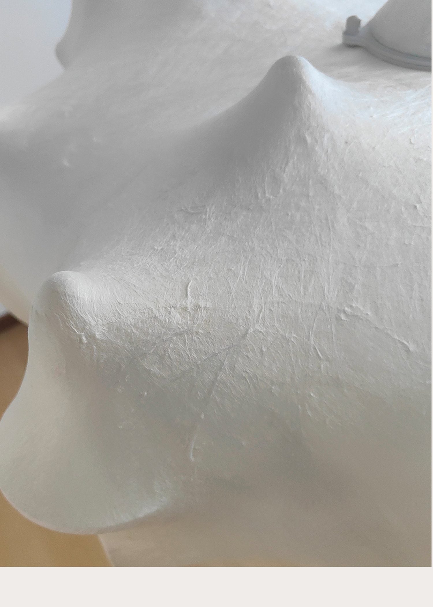 White sculptural folded pendant light detail