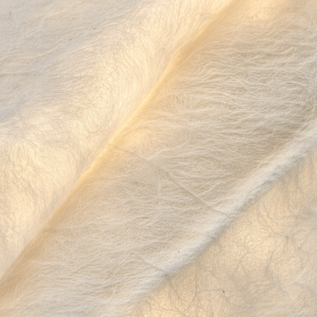 Warm light diffused through handmade mulberry silk fibers