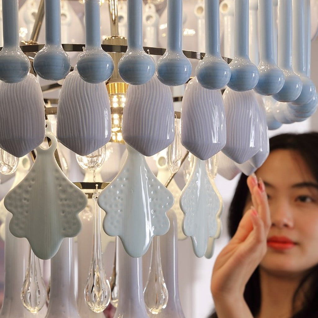 Blue ceramic lily forms and clear glass drops on chandelier