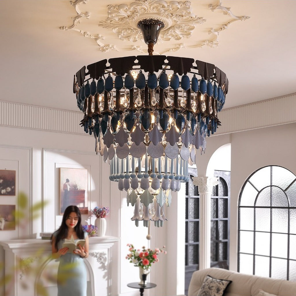 Blue ceramic chandelier lit in a styled living room