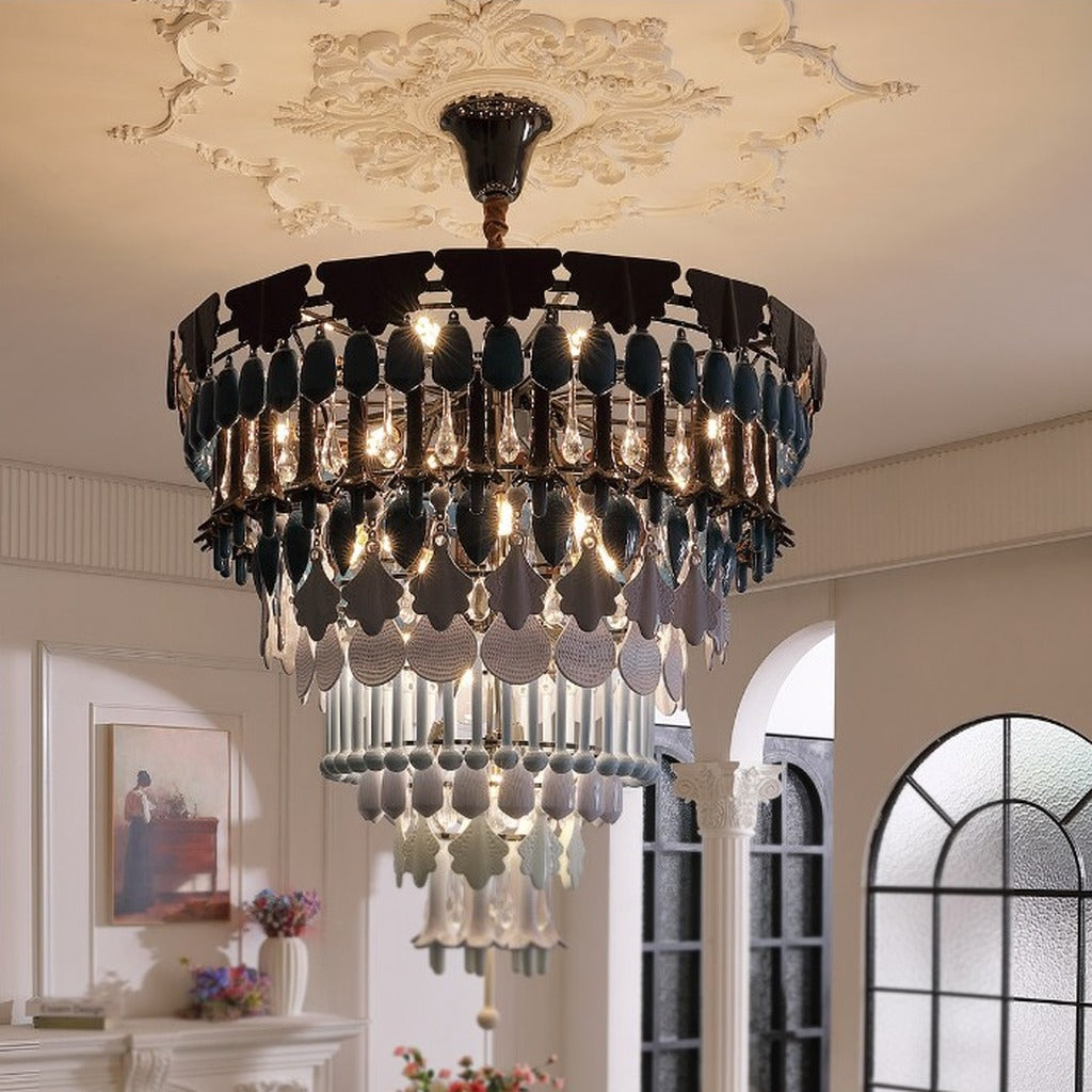 Tiered blue ceramic chandelier glowing in a living room