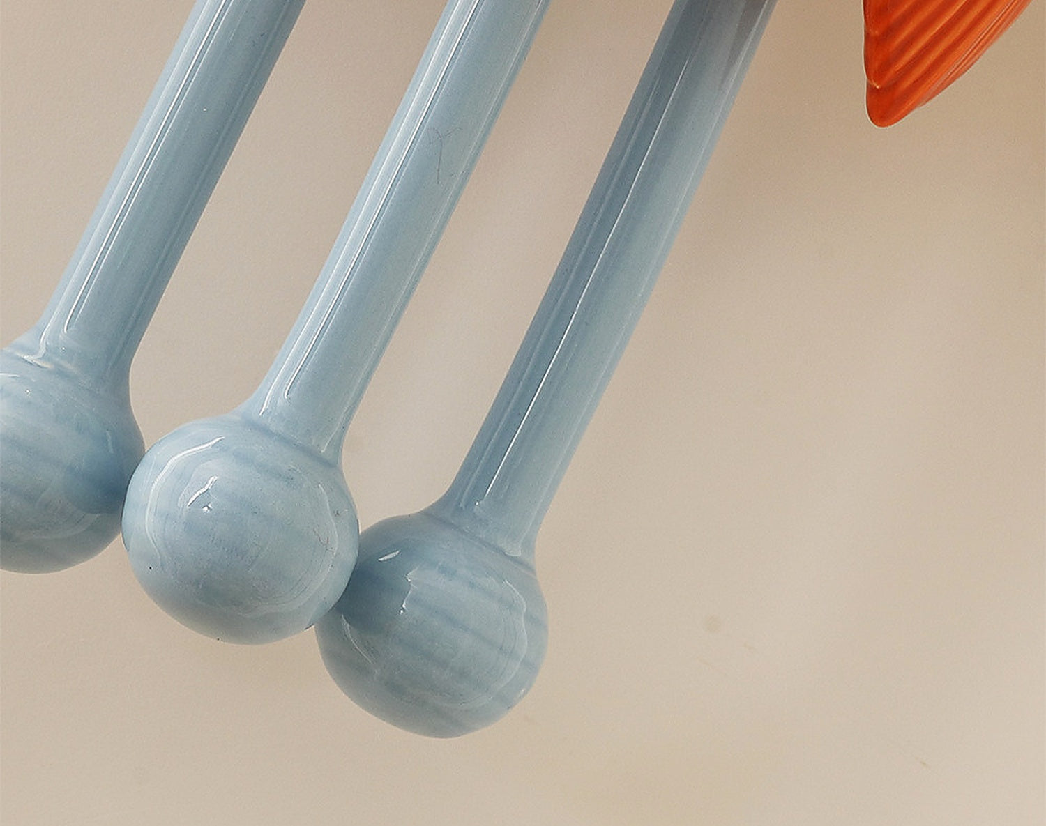 Orange ceramic leaves and blue ceramic stem detail