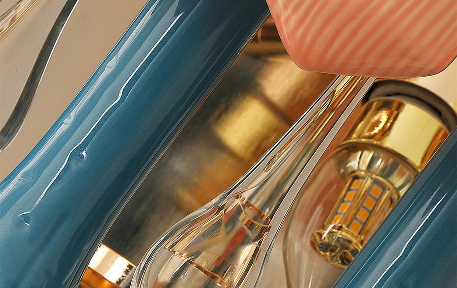 Glass drops and blue ceramic stems on colorful wall sconce